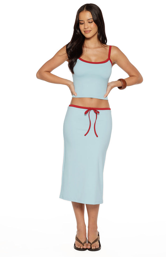 Front view of a light blue jersey midi skirt with a red tie waist and red trim