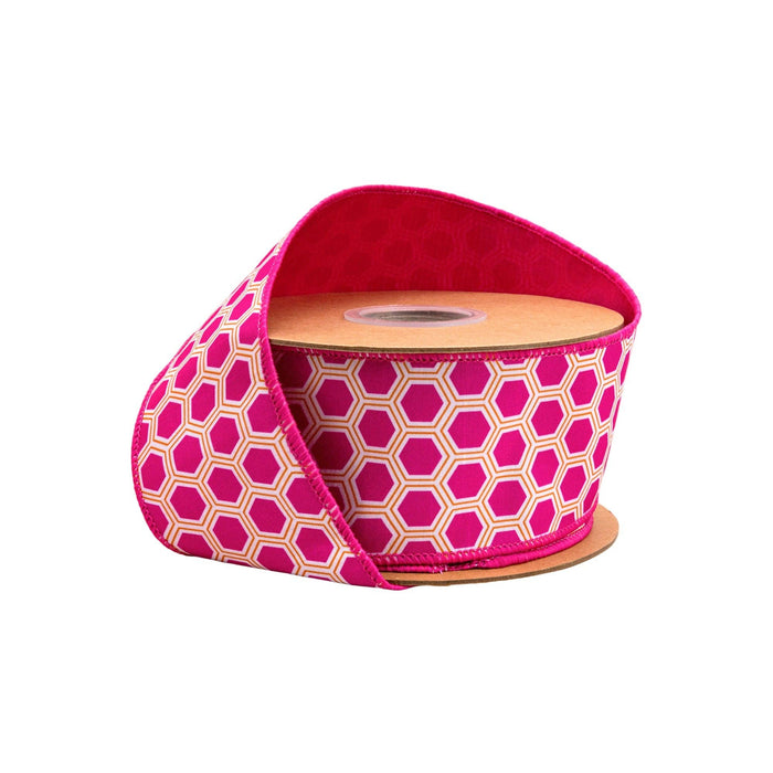 Roll of pink and beige patterned ribbon on a white background