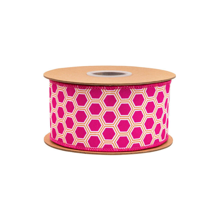 Spool of pink ribbon with geometric pattern on a white background