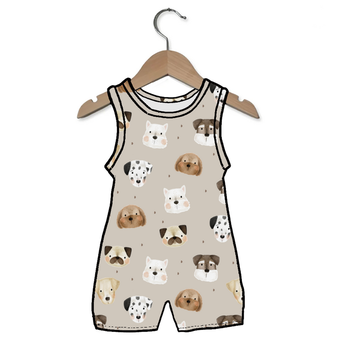 Children's sleeveless romper with dog pattern on a hanger against a white background