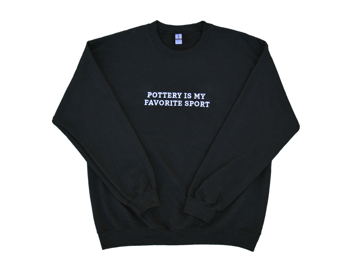 Black sweatshirt with white embroidered text 'Pottery Is My Favorite Sport' on the front.