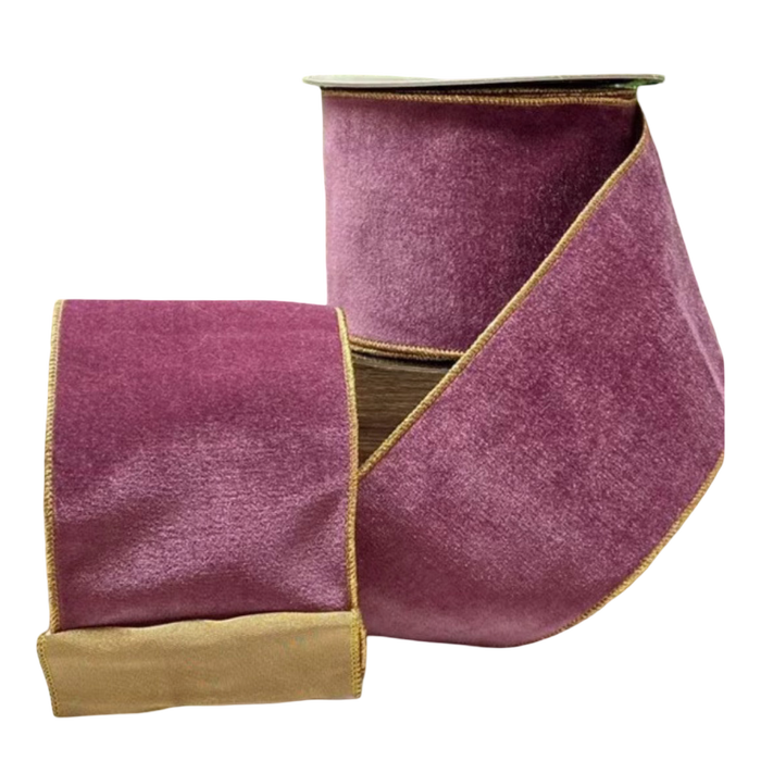 Rich purple velvet ribbon with gold backing and gold edging, 4 inches wide, shown unrolled from a 10-yard spool beside holiday greenery for trees, bows, wreaths, and garlands.