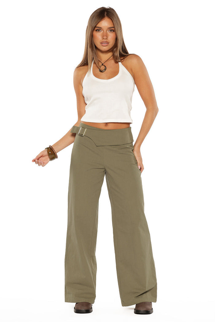 Full length view of the green straight leg pants with an asymmetric fold-over waist and buckle detail