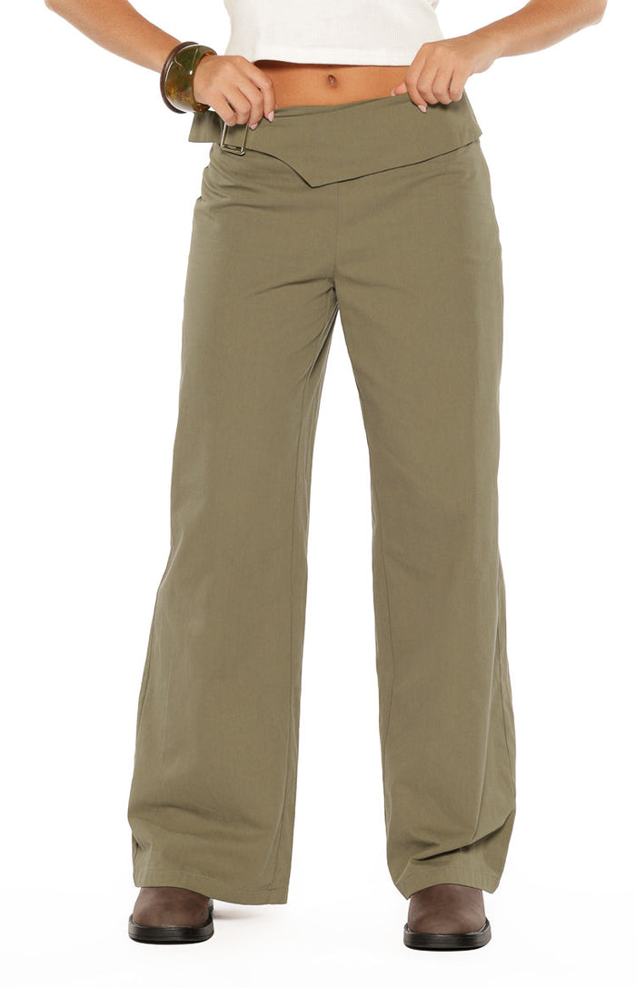 Front view of green straight leg pants with an asymmetric wide waistband and buckle detail