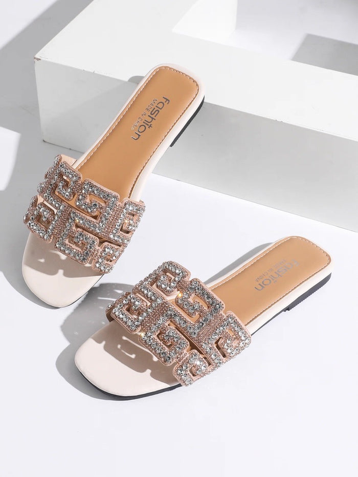 Pair of embellished slides on a light background