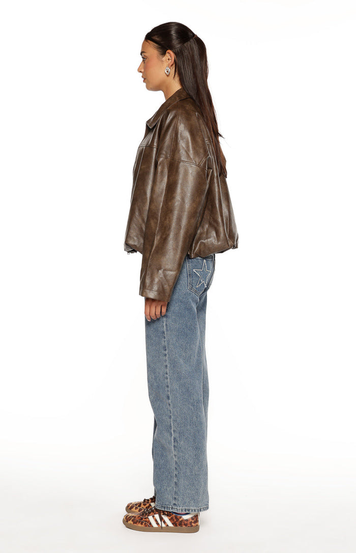 Side view of a brown PU bomber jacket with an oversized fit and bubble hem