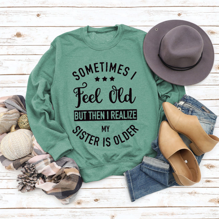 Light green sweater (black font) / S