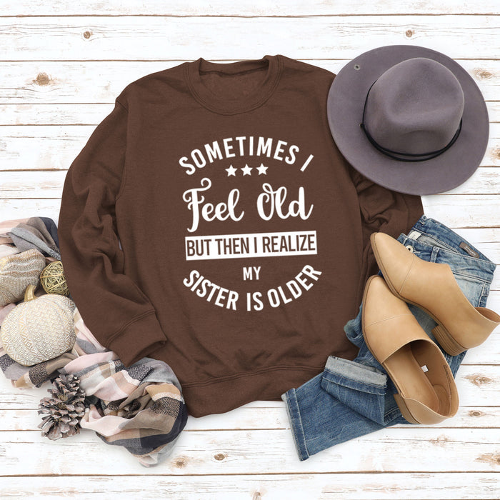 Coffee colored sweater (white font) / S