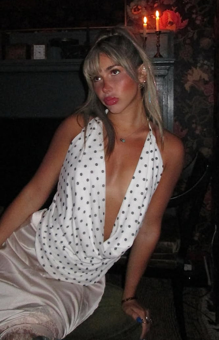 Beginning Boutique Rozie White Polka Dot Mesh Top white polka dot halter cowl neck sleeveless top with a deep V-drape