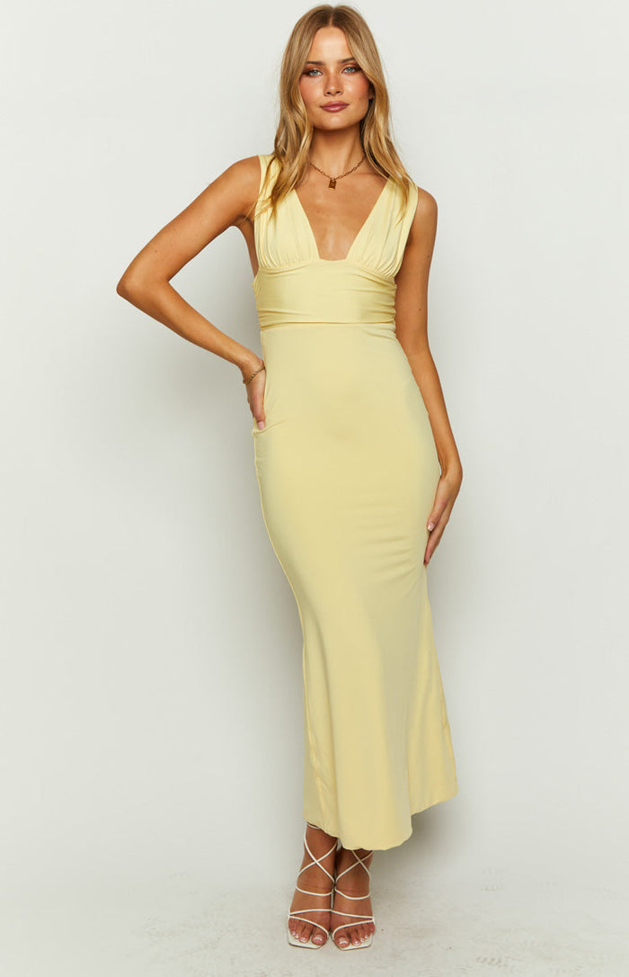 Front view of a yellow maxi dress with a deep V-neckline, ruched bust, and a flowing skirt