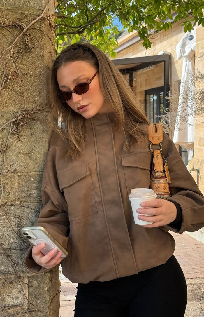 Brown oversized suedette jacket with a funnel neck and two chest flap pockets