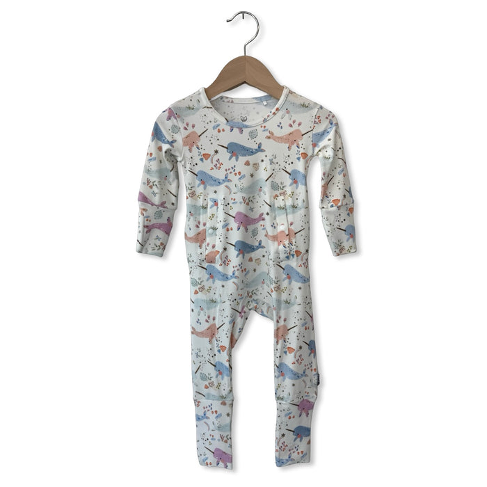 Children's onesie with animal pattern on a hanger against a white background