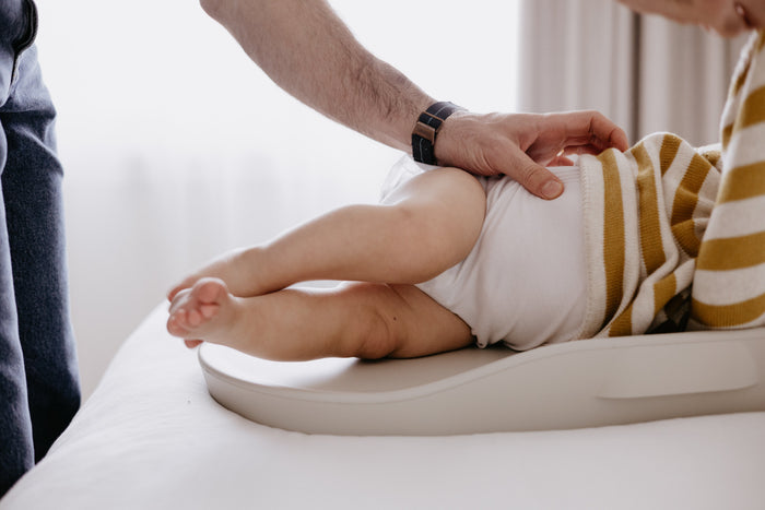 Baby on Tasman Eco Touzy Change Mat surface, perfect for baby strollers and changing needs