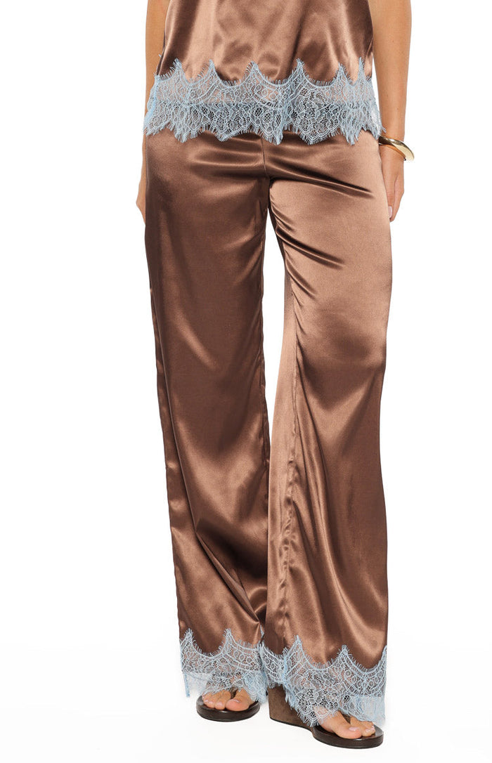 Front view of flowy brown satin pants with light blue lace trim detailing at the wide hem