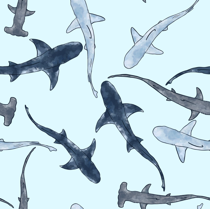 Watercolor pattern of various sharks and hammerhead sharks swimming on a light blue background.