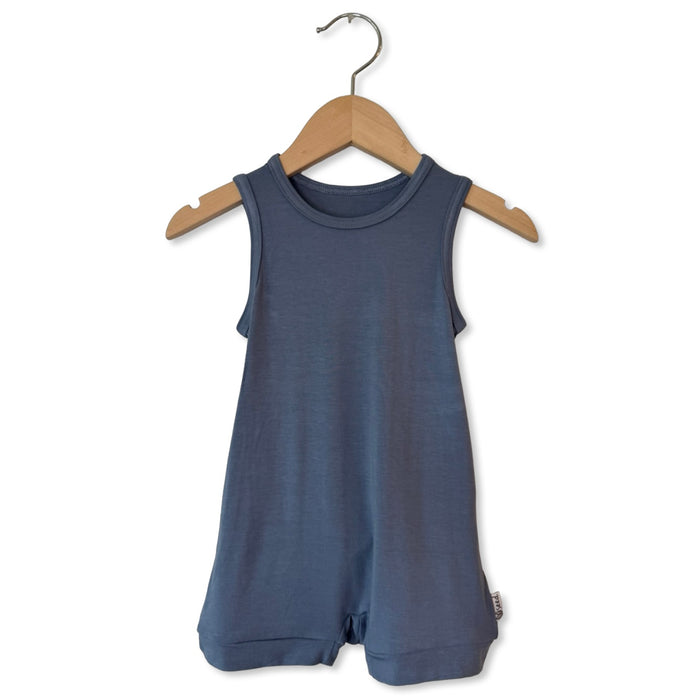 Blue romper on a wooden hanger against a white background