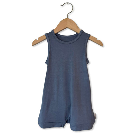 Blue romper on a wooden hanger against a white background