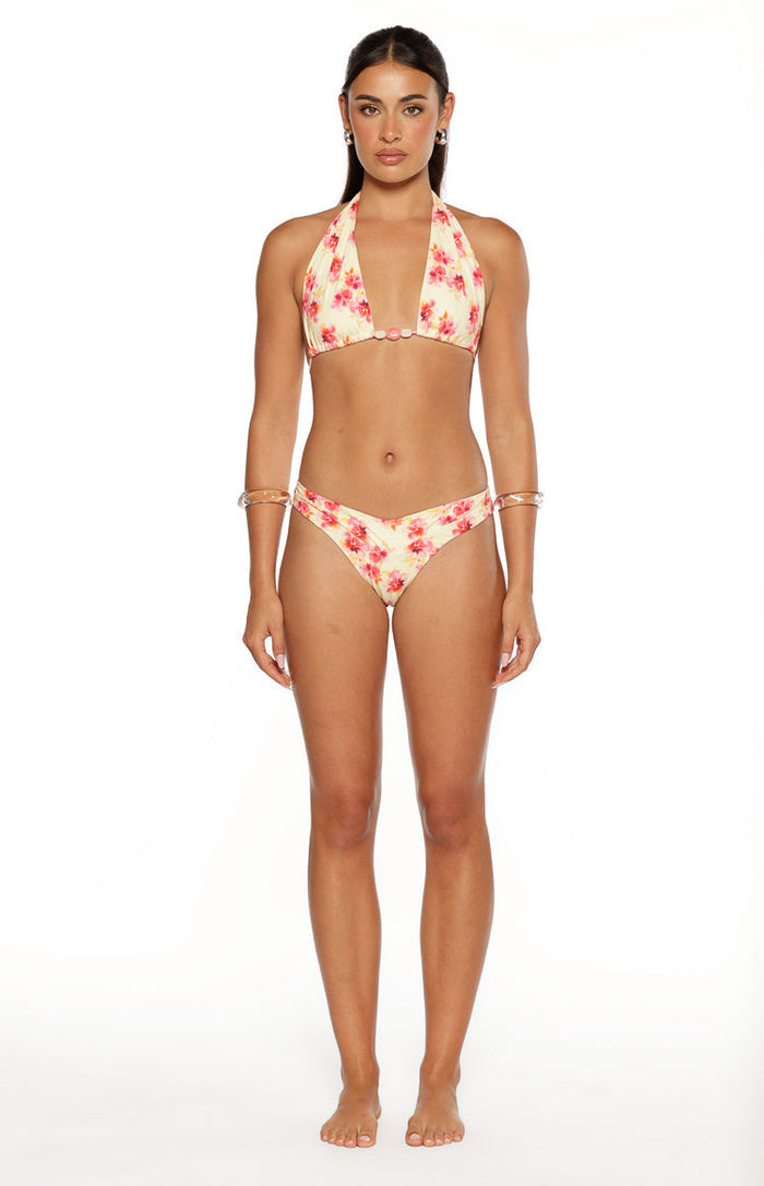 Sunbeam yellow halter bikini top with pink floral print and a small pink beaded detail at the center