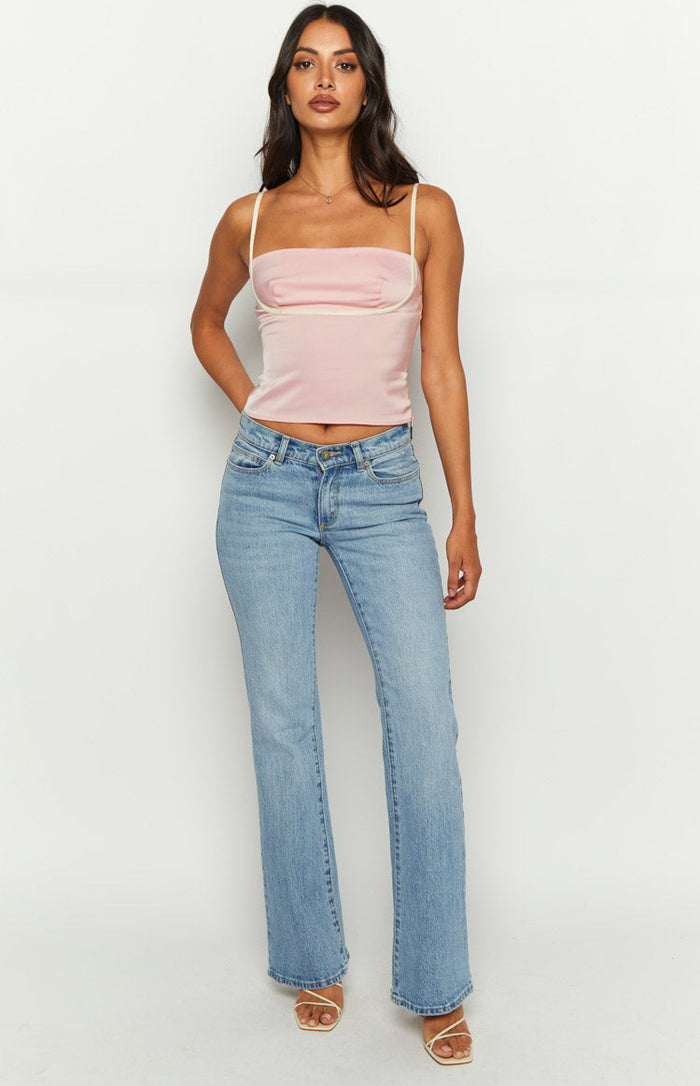 Front view of a pink bandeau top with cream piping and thin straps