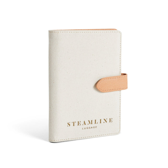 Angled view of the Navigator leather passport holder in white with desert glitter trim and logo