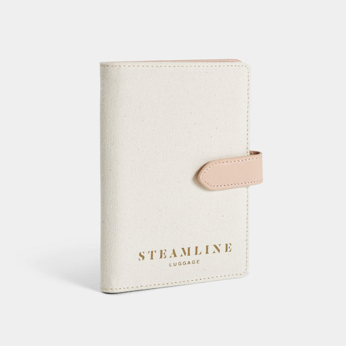Angled view of the Navigator leather passport holder in white with stone trim and logo
