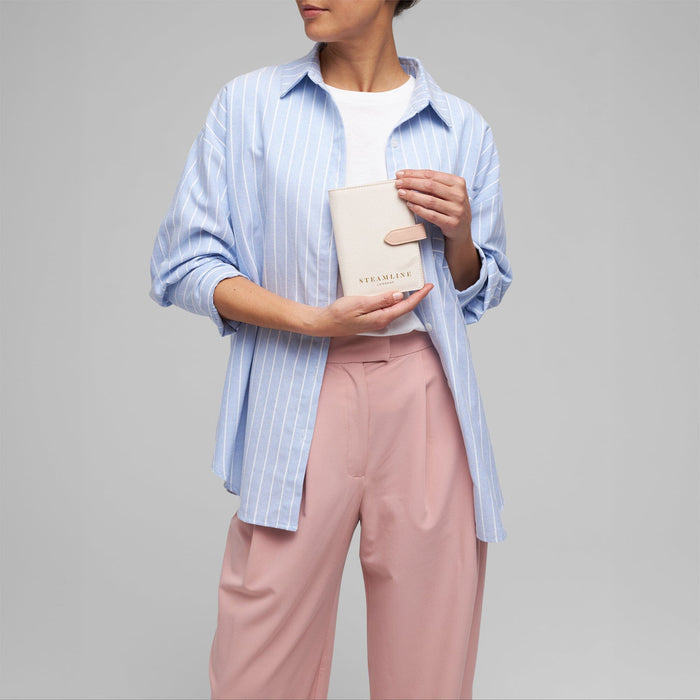 Model with the Navigator leather passport holder in white with stone trim