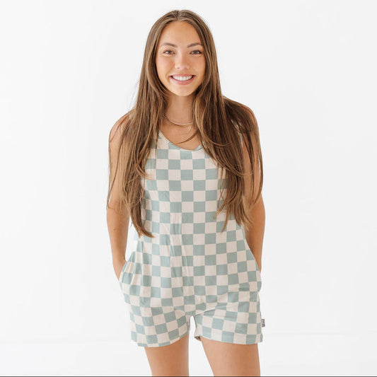 Woman wearing a checkered romper on a white background