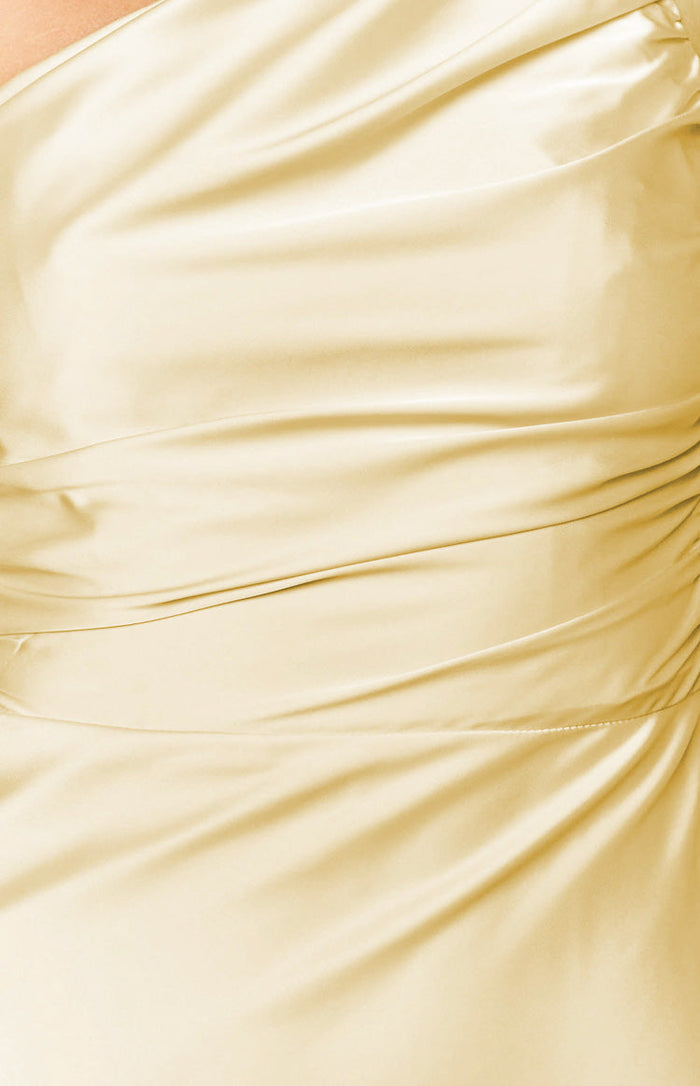 Close-up of the yellow maxi dress fabric with elegant draping and side ruching