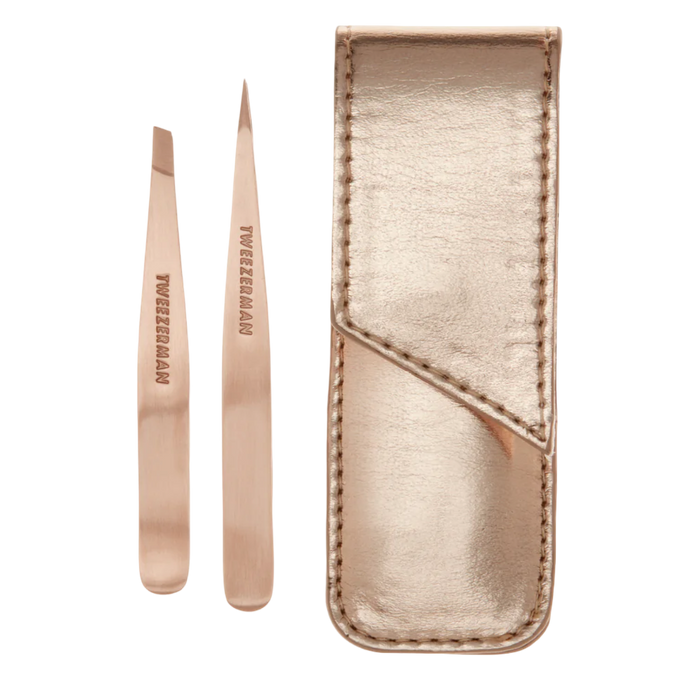 Rose gold tweezers with a matching case on a white background