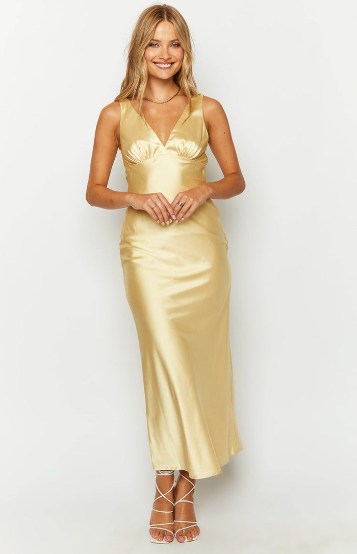 Front view of a yellow satin maxi dress, highlighting the V-neckline and gathered bust