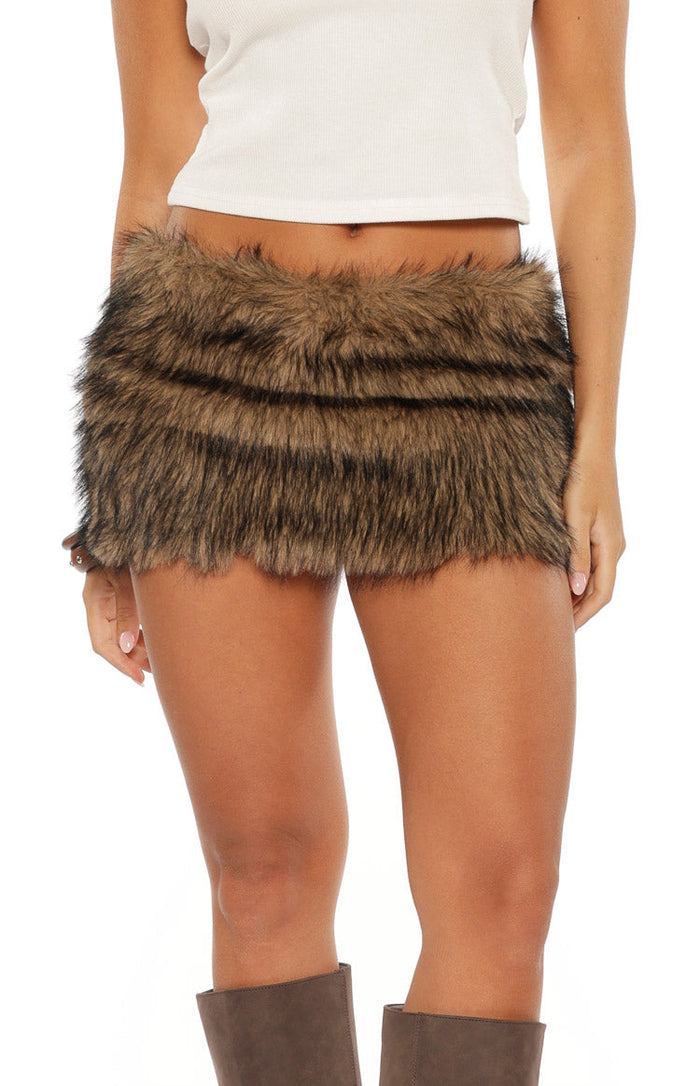 Close-up front view of a brown faux fur mini skirt with layered texture and a shaggy hemline
