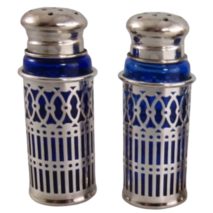 Vintage Japanese cobalt blue glass salt and pepper shakers with ornate silverplate filigree sleeves, sold as a coordinating set of two.