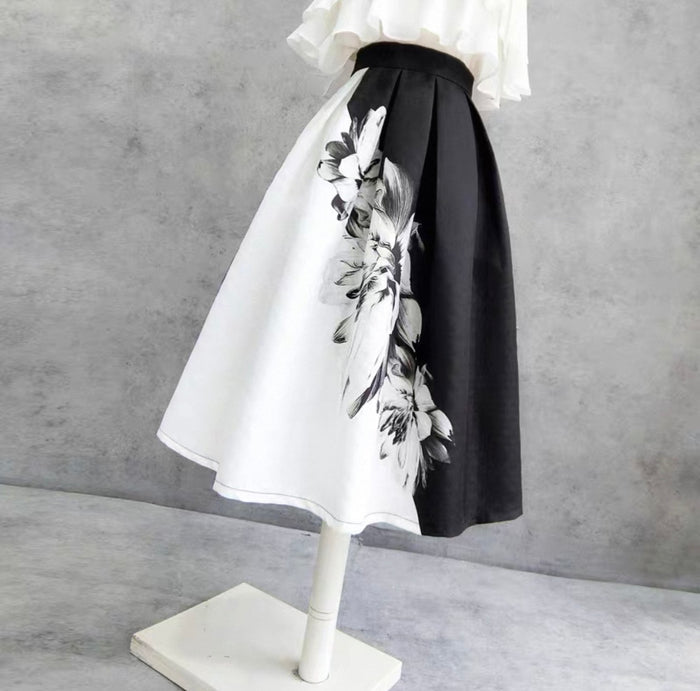 Skirt with black and white floral pattern on a mannequin against a gray background
