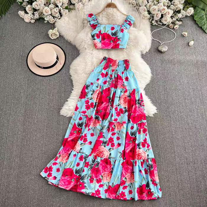 Floral dress with matching top on a textured surface with flowers and a hat.