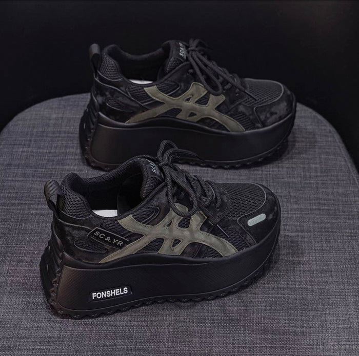 Black platform sneakers with 'FONSHELS' branding on a textured surface.