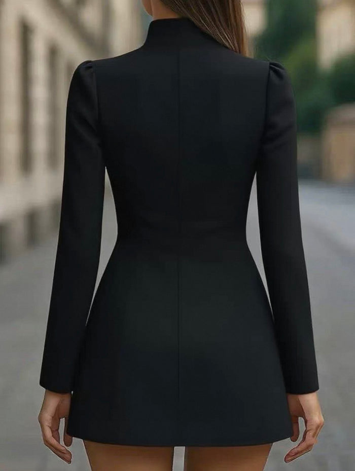 Black dress with long sleeves and high neckline on a blurred street background