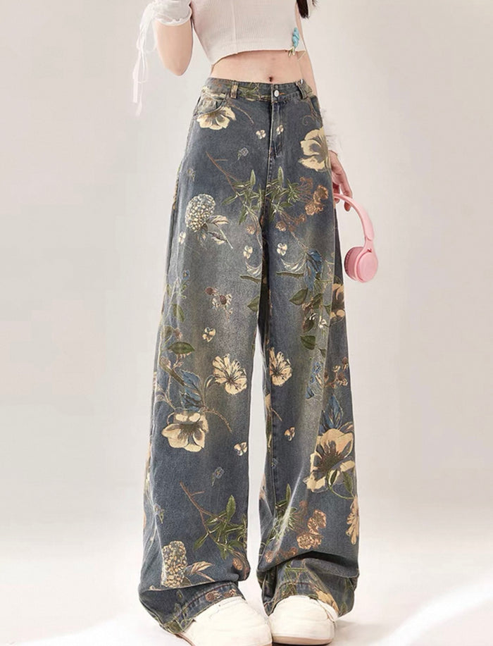 Floral-patterned jeans worn by a person on a white background