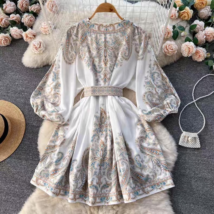 Floral patterned dress on a hanger with decorative items around