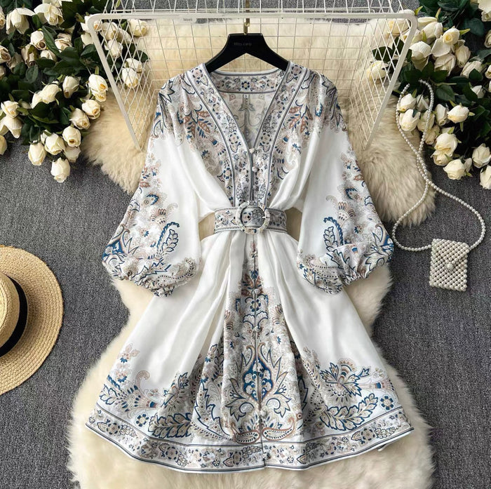 Floral-patterned dress on a hanger with decorative elements on a textured surface