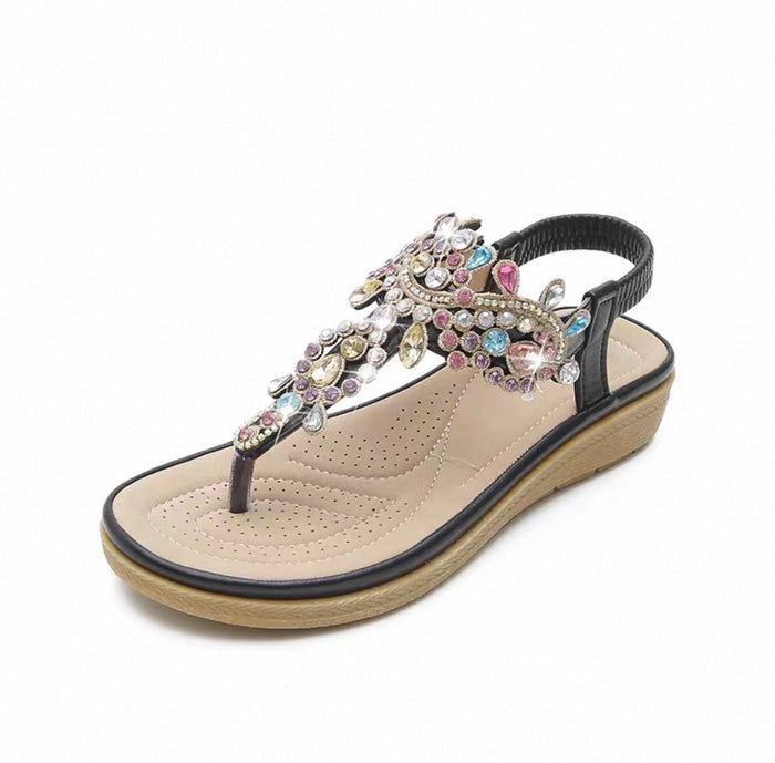 Beige sandal with decorative multicolored embellishments on a white background