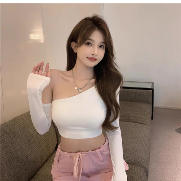 Woman wearing a white top and pink pants in a living room setting