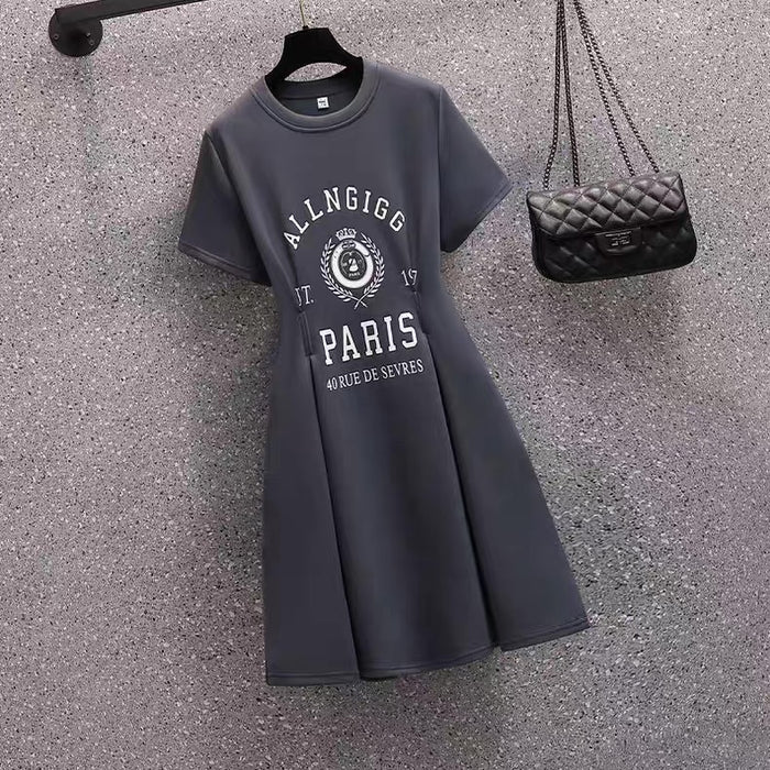 Gray dress with 'ALLNGIGG PARIS' text and a black handbag on a textured surface