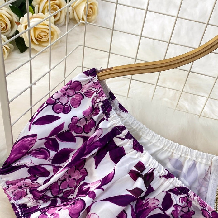 Purple floral skirt on a hanger with white roses in the background