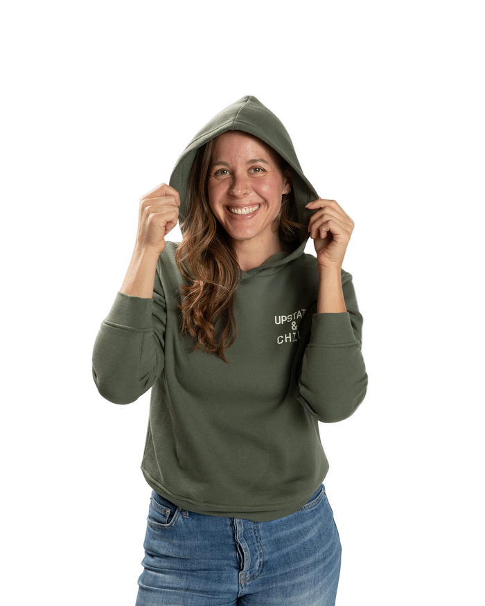 Woman wearing a green hoodie with text on a white background