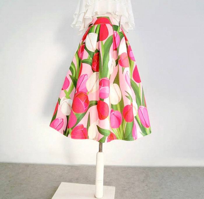Floral skirt on a mannequin against a plain background