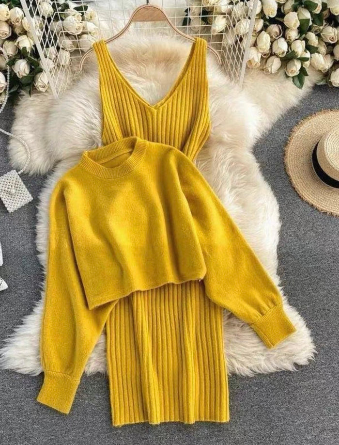 Mustard yellow sweater and skirt set on a hanger with decorative background