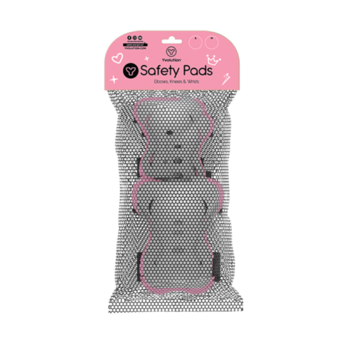 Child wearing pink Yvolution safety pads while riding a scooter