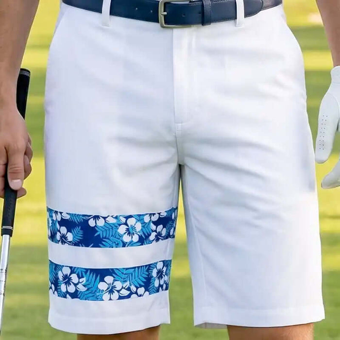 White golf shorts with blue floral pattern on a golf course